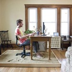 A man brainstorming amazing house ideas on his computer.