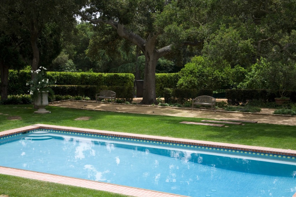 A swimming pool in a classic manor house garden.
