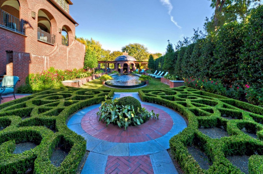 Classic garden with a circular topiary and a fountain in a manor house.