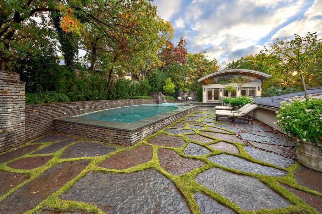 A classic manor with a stone patio.