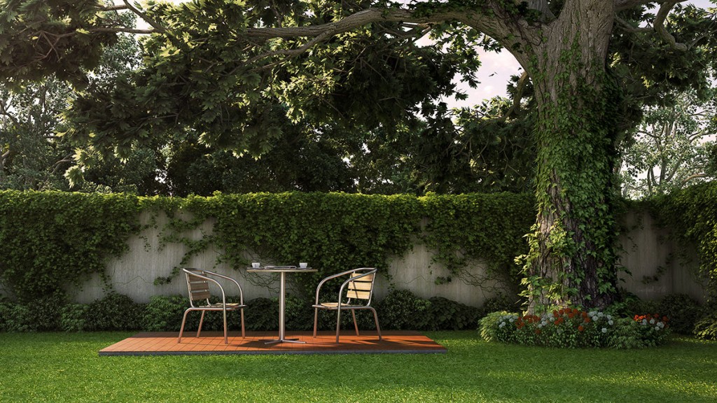 A classic manor house garden with a table and chairs.