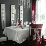 A dining room decorated with red and white tablescapes for Christmas.