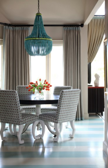 A dining room with blue and white striped floors that serves as a conversation piece.