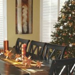 A dining room tablescapes with a Christmas tree.