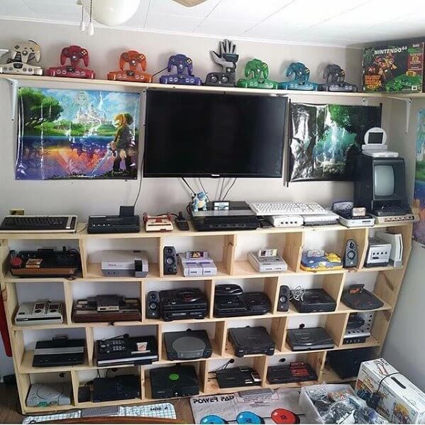 A gaming room filled with video game consoles on shelves.
