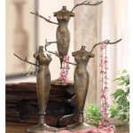 Three bronze mannequins on top of a table used for key storage ideas.