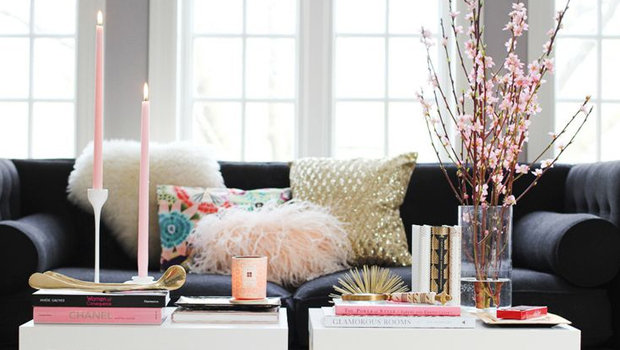 A living room with a pink coffee table.