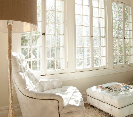 Living Room Ideas: A white chair and ottoman in front of a window, creating a cozy setting.