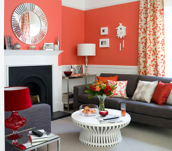 The secret to taming a fiery red? Balance it with pops of white. A smattering of dove white wall accents with the white fireplace, chair rail, and coffee table keep the bold color in check.