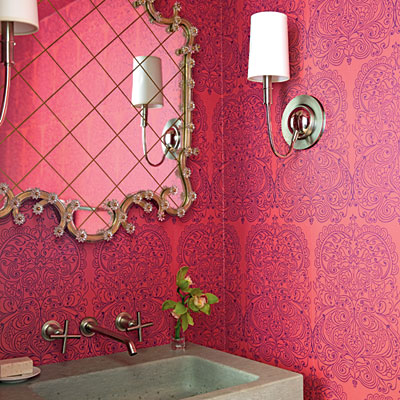 A brightening bathroom with a pink wall.