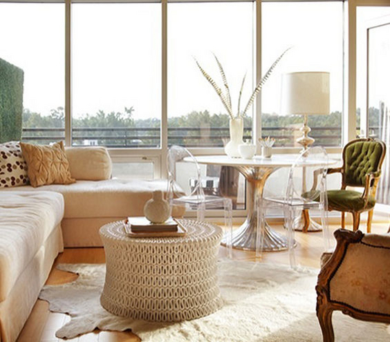A spacious living room with large windows and a white couch.