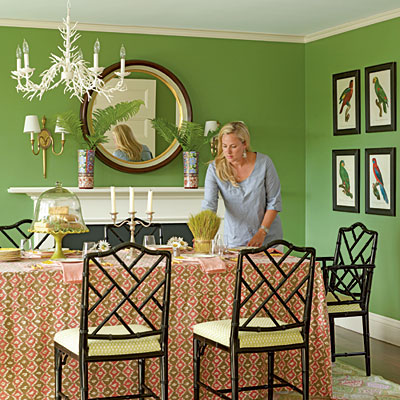 A woman brightening a green dining room.