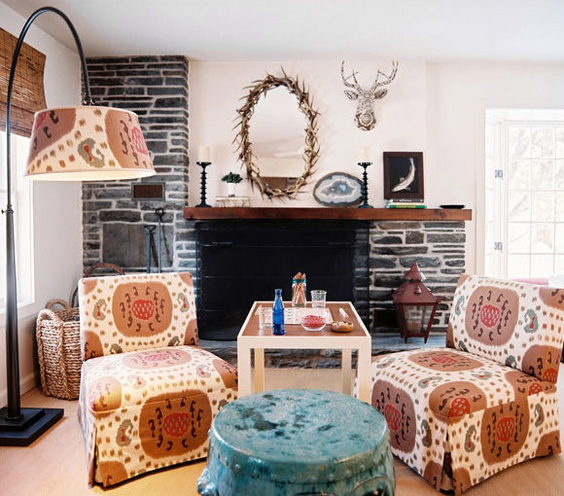 A rustic retreat gets a pop with slipper chairs covered in a tribal ikat. It gives the outdoorsy cabin a feminine spin. Interior design by Tilton Fenwick.
