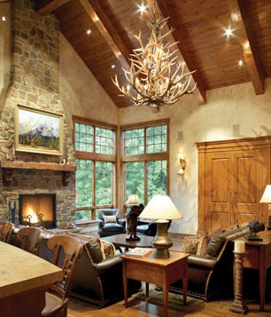A living room with a fireplace and chandelier.