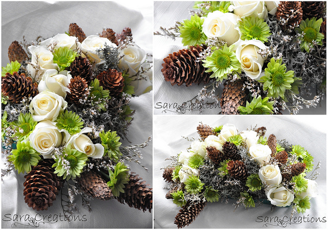 Winter Floral Arrangement featuring white roses and pine cones.