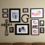 A living room with create a collage of framed pictures and a cross on the wall.