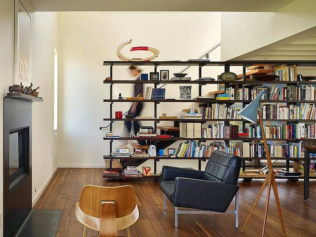 A living room with bookshelves serving as a room divider.