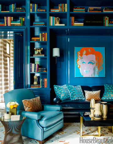 A classic library with blue walls and bookshelves.