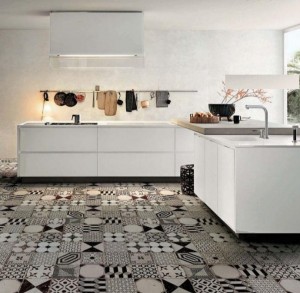 A white and black kitchen with patchwork tiles.