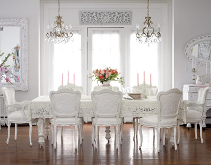A white dining room with chandelier inspiration.