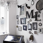 A room filled with a multitude of framed pictures arranged to create a collage on the wall.
