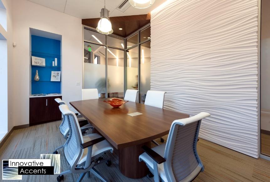 A conference room with a white table and chairs, featuring a focal wall.