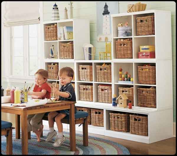 Two children organizing toys in a playroom with wicker baskets.