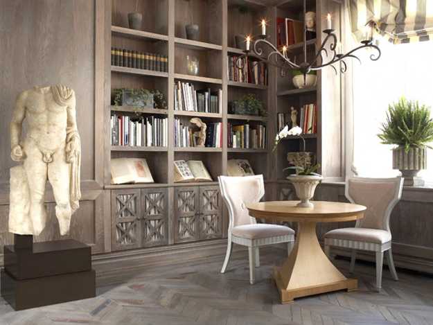 A room with built-in bookshelves and a statue.