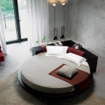 A unique circular bed in a room with concrete walls.