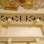 A white dresser with two drawers to hide tissue boxes.