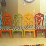 A row of unique dining chairs in a colorful kitchen.