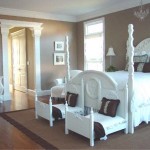A white bedroom with a four poster bed and dresser, perfect for entryways.