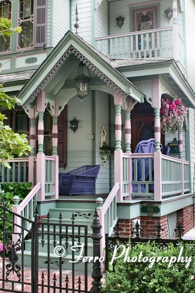 A victorian style home with a blue entryway.