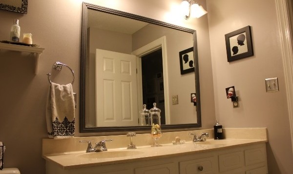 A remodeled bathroom with two sinks and a mirror.