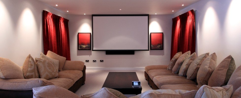 A movie room with couches and a projector screen.
