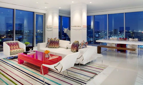 A living room with a colorful striped rug.