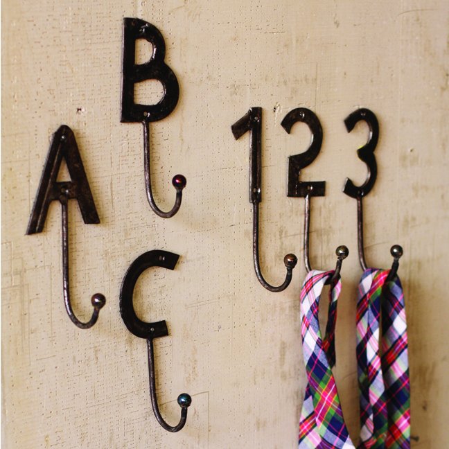 A set of decorative hooks with numbers and ties hanging on the wall.
