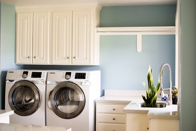 A laundry room with a washer, dryer, and laundry chute.