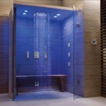 A bathroom with a glass shower and unique blue lights.