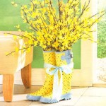Festive vase of yellow flowers and rubber boots.