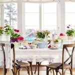 A festive dining room with flowers on the table, perfect for spring time home ideas.