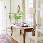 An entryway with a table and chairs and a rug.
