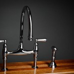 A chrome kitchen faucet on a wooden table, one of the top 15 best looking kitchen faucets.