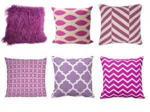 A collection of radiant orchid and white patterned pillows.