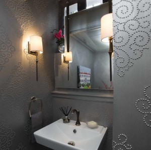 A powder room with grey wallpaper and a sink.