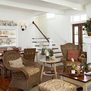 A nature-inspired living room with wicker furniture and a fireplace.