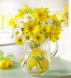 Yellow and white daisies in a pitcher, perfect for summer decorating ideas.