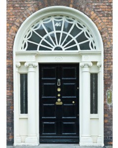 A black door with an arched window that brings bad luck.