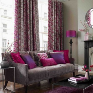 A living room with pink decor in line with Fall 2014 design trends.