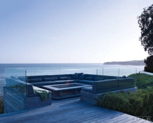A wooden deck with a fire pit perfect for enjoying the ocean view.